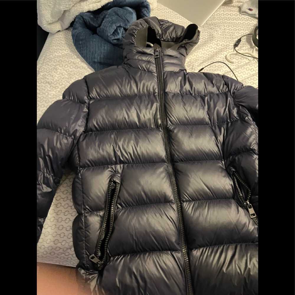 I am selling a Calvin Klein Navy Blue Puffer Jacket.